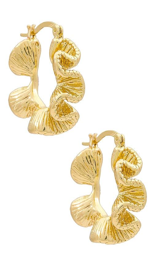 amber sceats x revolve wave hoops in metallic gold.