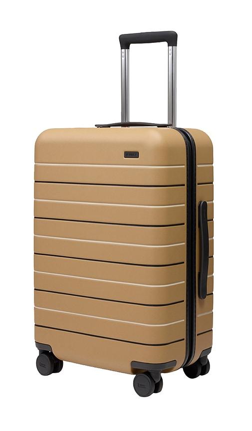 away the bigger carry-on suitcase in tan.