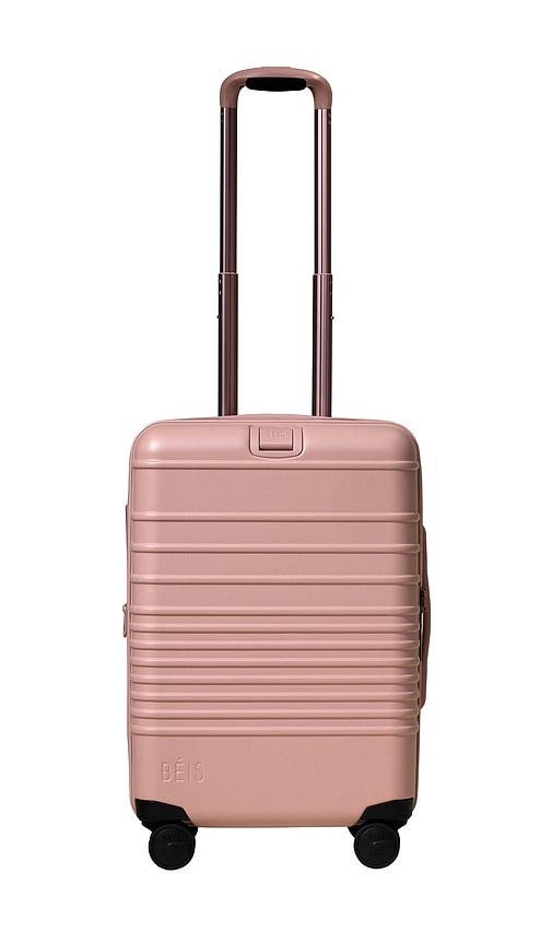 beis the carry-on roller in pink.