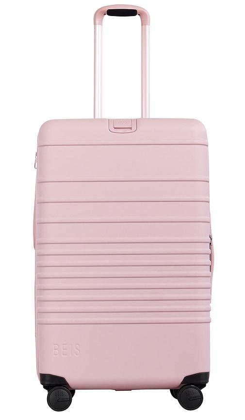 beis the medium check-in roller in pink.