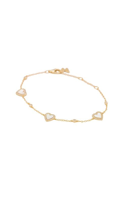 by adina eden eden pave heart bracelet in metallic gold.