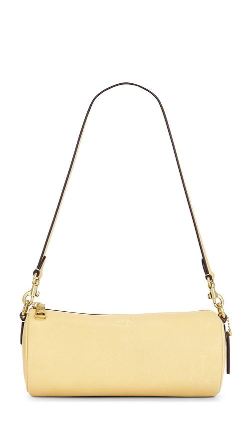 coach natural grain leather barrel bag in yellow.