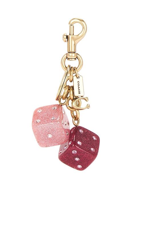 coach resin dice bag charm in pink.
