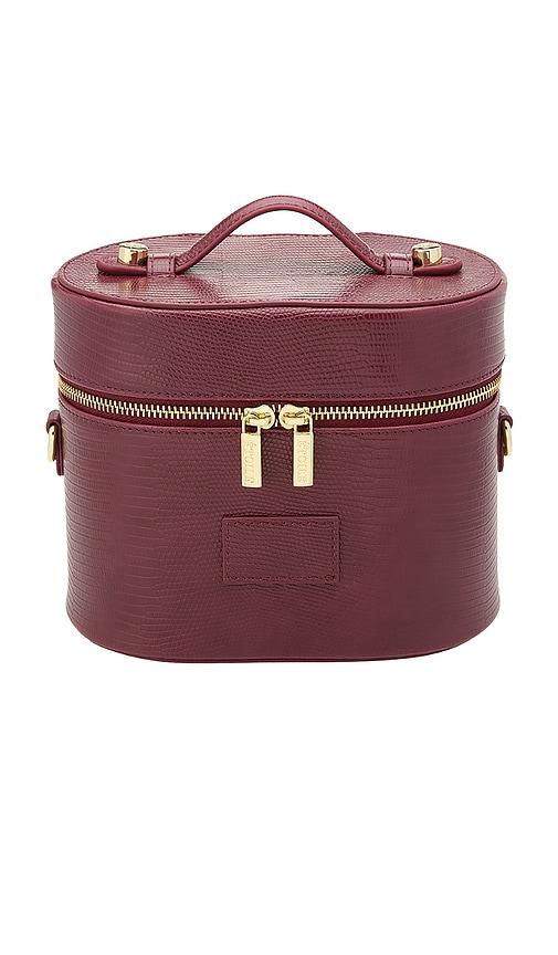 etoile collective oval toiletry case in burgundy lizard print.