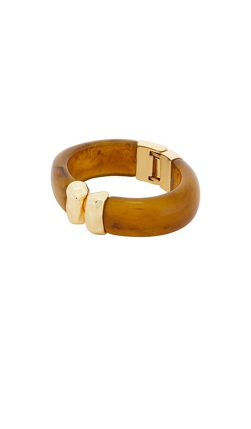 ettika carved relic cuff in brown.