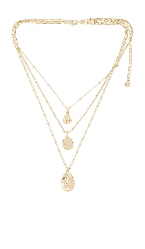 ettika circle flow layered necklace set in metallic gold.