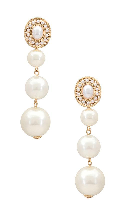 ettika graduating pearl dangle earrings in metallic gold.