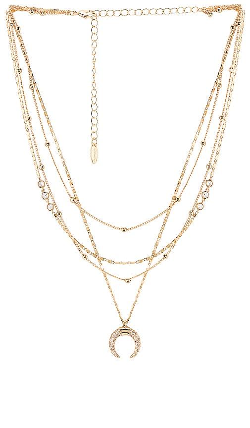 ettika layered moon necklace in metallic gold.
