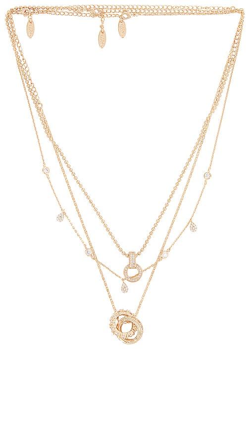ettika layered pendant necklace in metallic gold.
