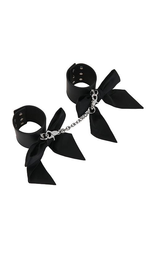 fleur du mal leather cuffs with silk bows in black.