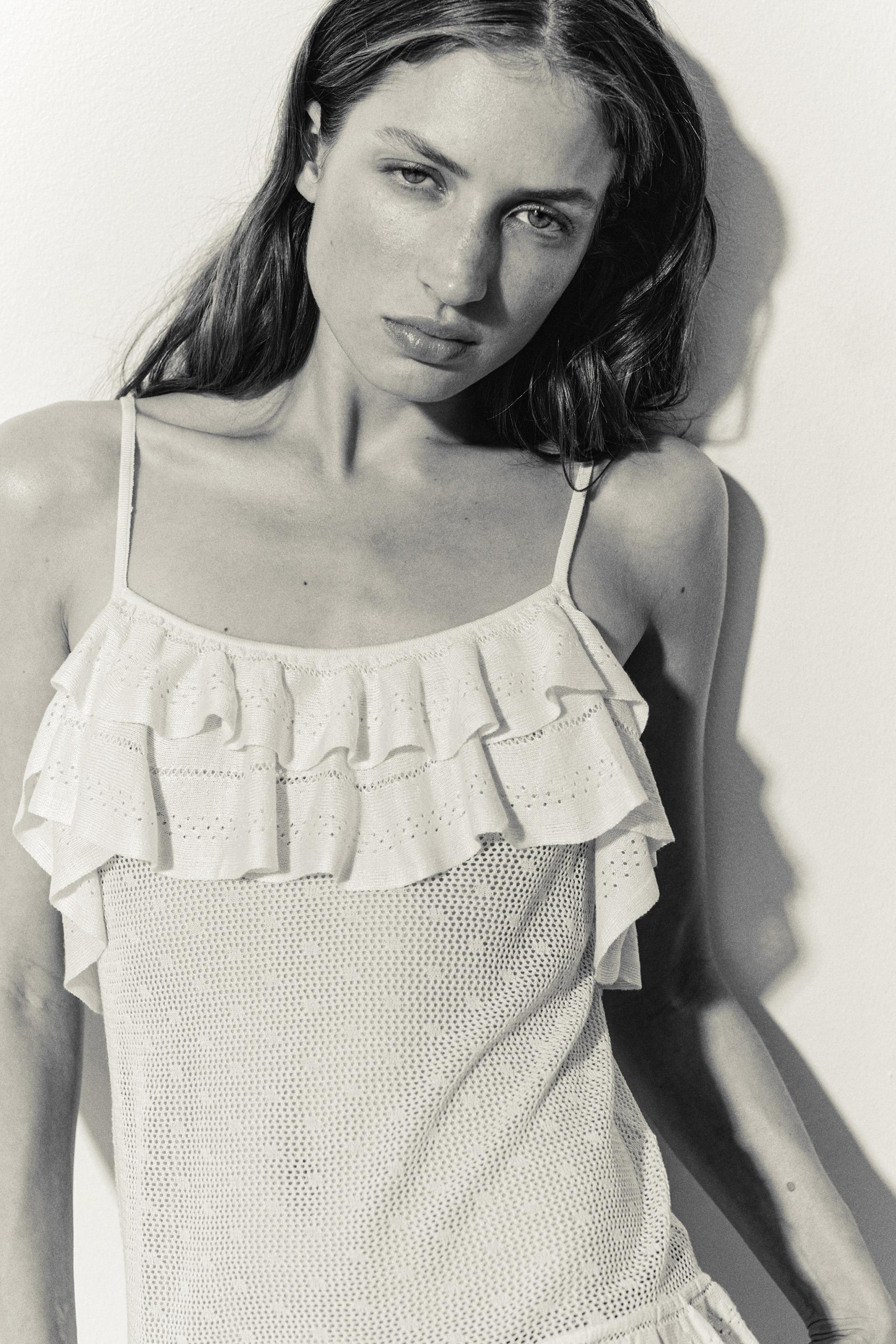 flounced pointelle-knit top