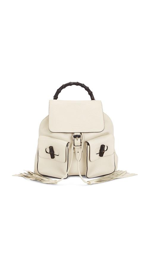 fwrd renew gucci bamboo tassel backpack in white.
