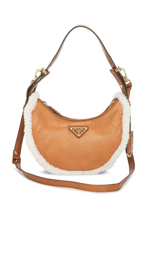 fwrd renew prada shearling arque shoulder bag in tan.