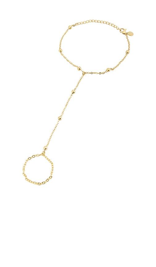 petit moments sol hand chain bracelet in metallic gold.