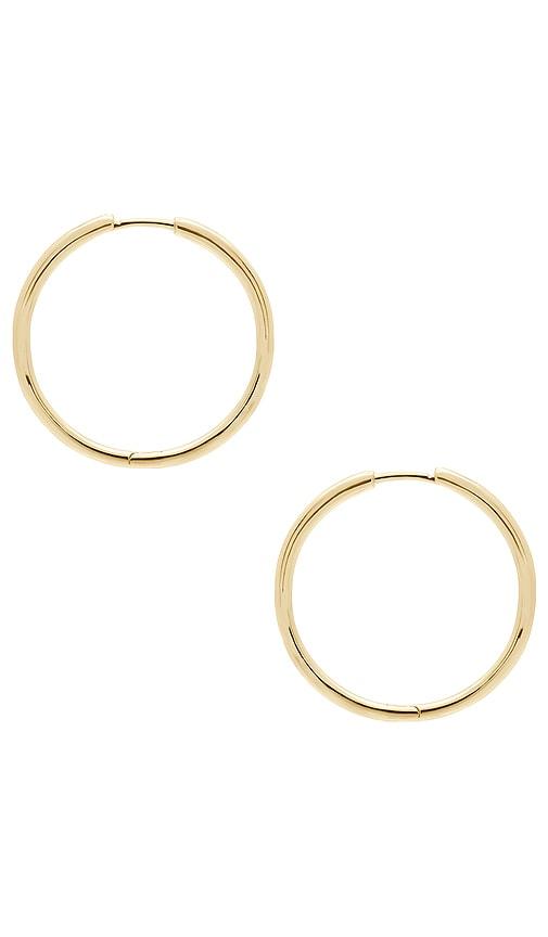 shashi essential hoop earrings in metallic gold.
