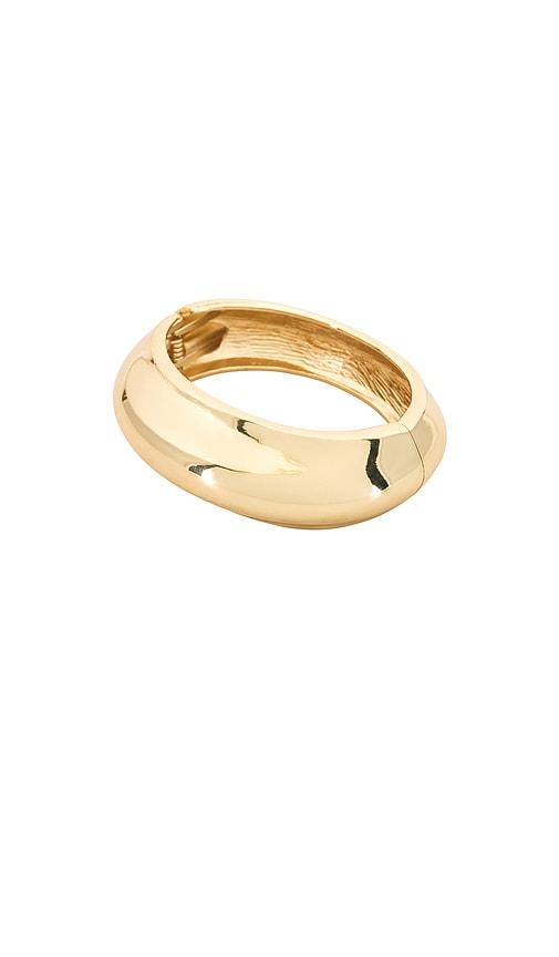 shashi sphere bangle bracelet in metallic gold.