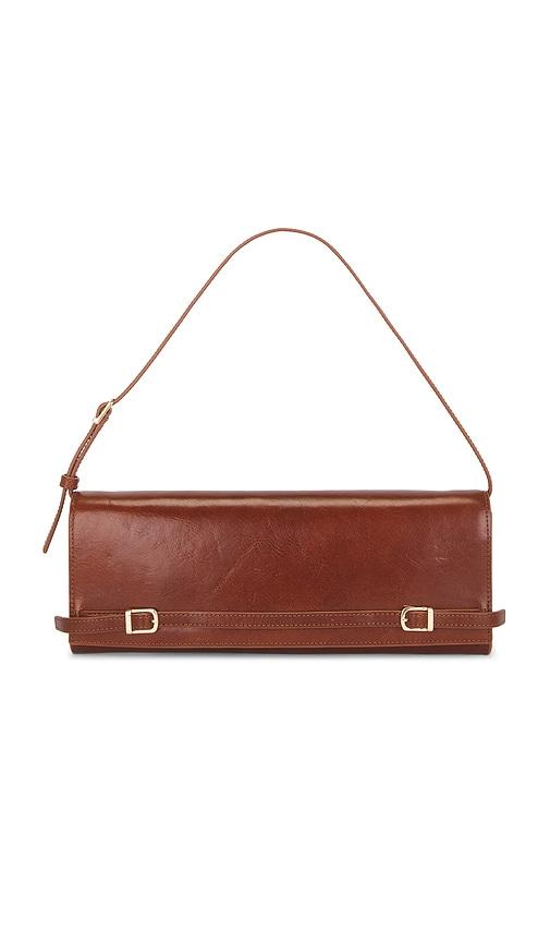simkhai river east west vachetta leather clutch in cognac.