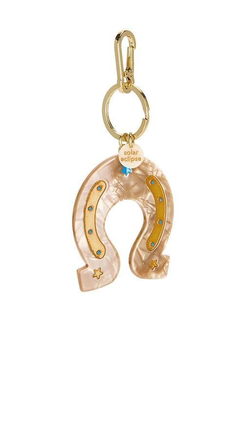 solar eclipse hand-painted bag charm in tan.
