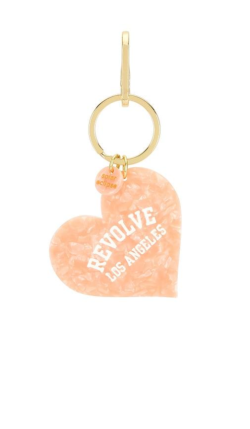 solar eclipse x revolve hand-painted los angeles collegiate heart bag charm + keychain in pink.