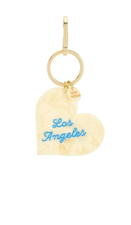 solar eclipse x revolve hand-painted los angeles heart bag charm + keychain in yellow.