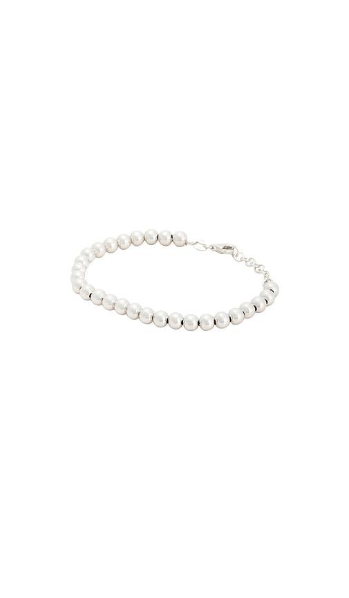 stone and strand silver ball bracelet in metallic silver.