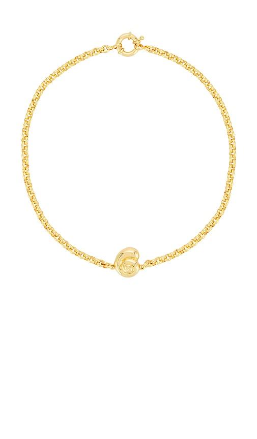 timeless pearly shell charm bracelet in metallic gold.