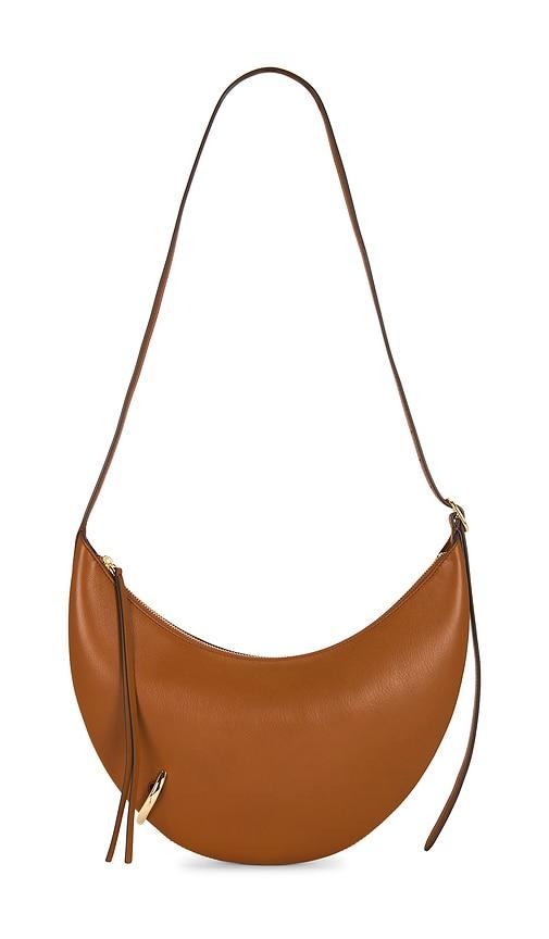 tory burch pierced crossbody bag in tan.