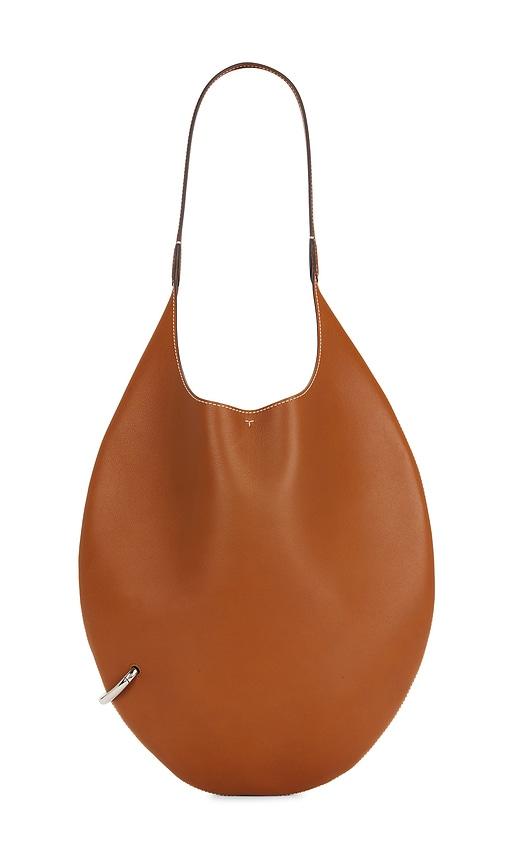 tory burch pierced soft bag in tan.